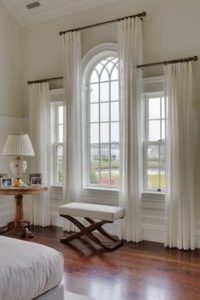 Arch window with drapery at varying heights